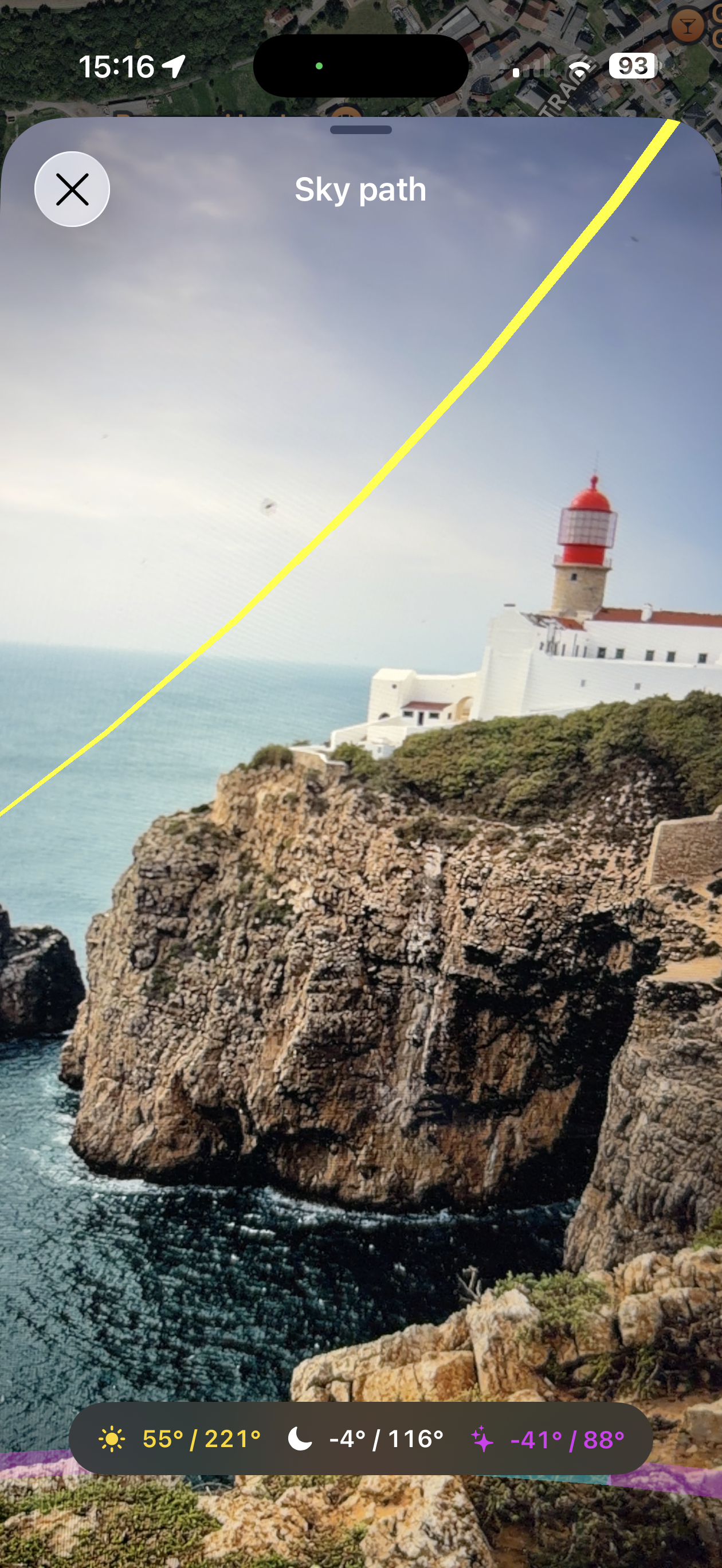 LensTrails live sky-path view showing the sun, moon, and Milky Way over a lighthouse composition